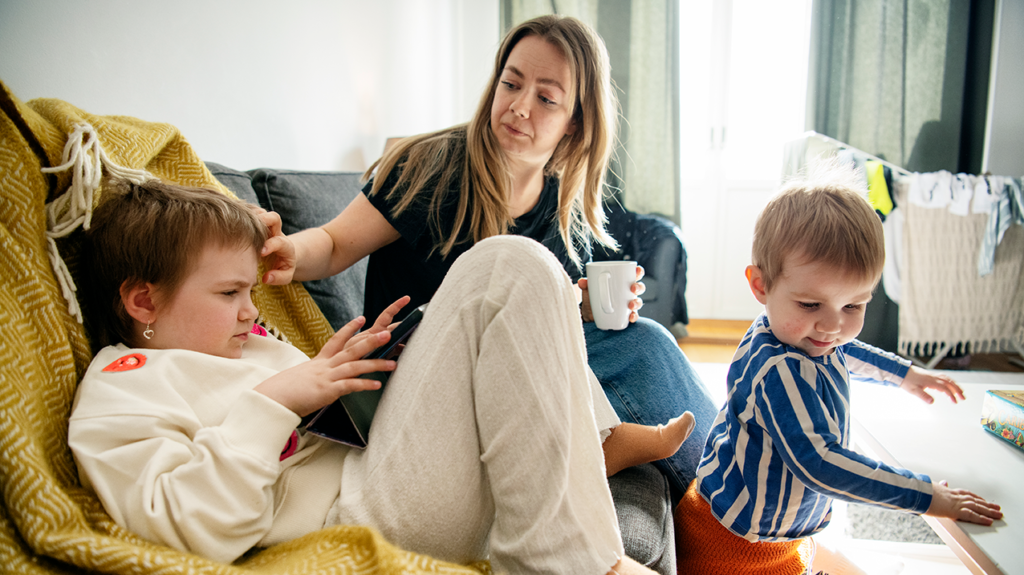 Isabelle sitter i en soffa med sin dotter och son.
